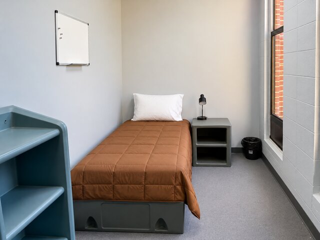 Warm orange-themed bedroom for a resident